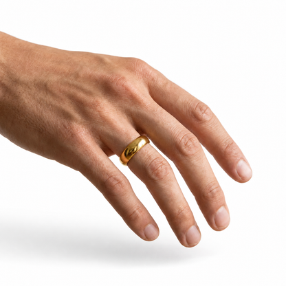 A gold band ring with a polished, rounded leaf-like shape worn on a person's ring finger, shown against a plain white background.